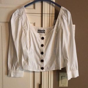 White top with large brown buttons